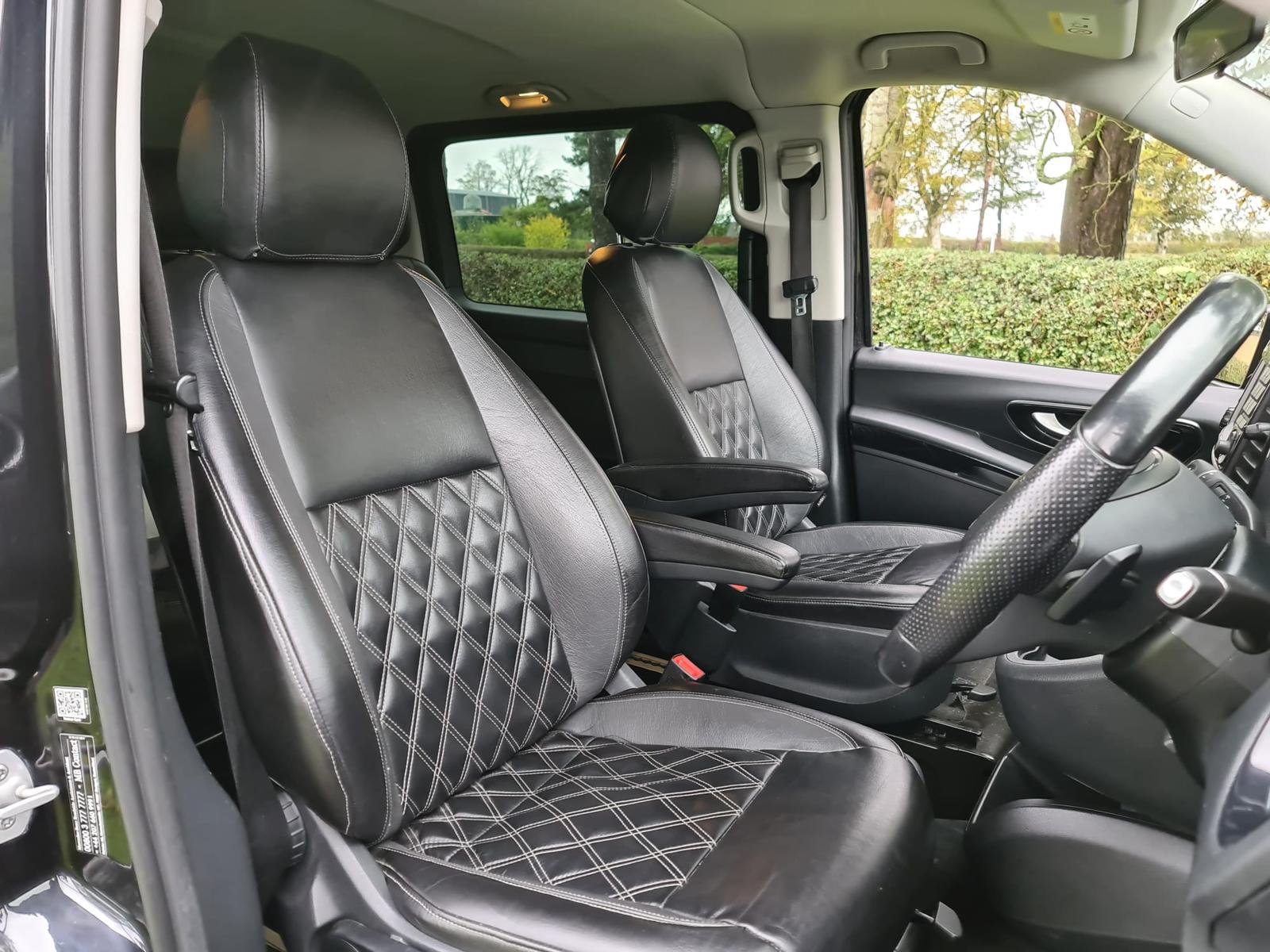 Black leather diamond stitched front seats in luxury chauffeur vehicle